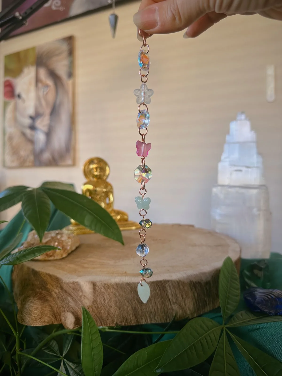 beaded crystal suncatcher held up over plants